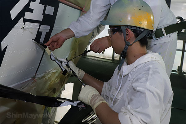 Peel off the masking tape from the part where the letters are overpainted on the aircraft color. The paint dries, so you don't even need a stuffy mask.